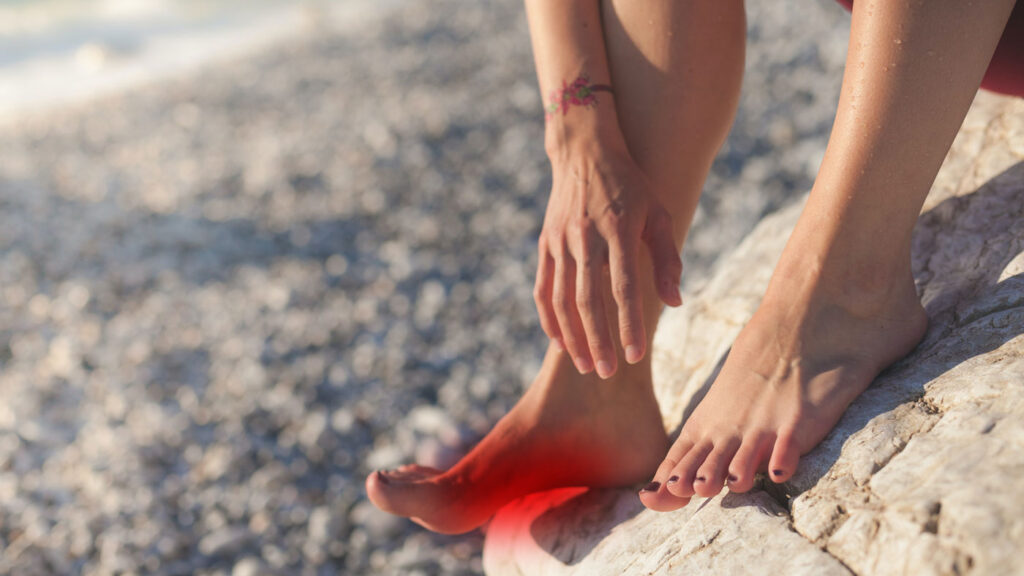 foot on rock with red pain