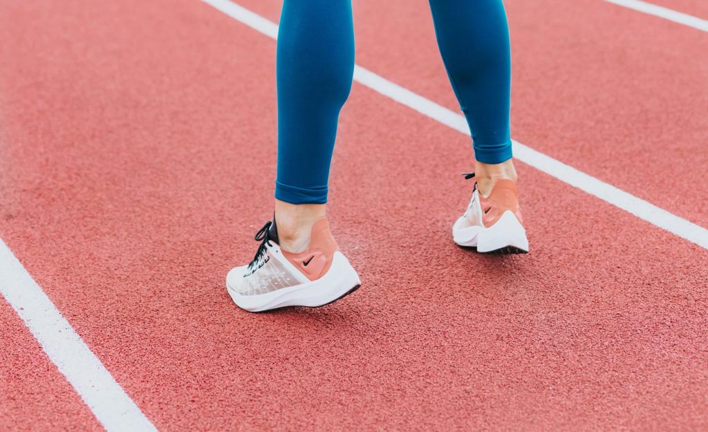 woman;s legs on a race track