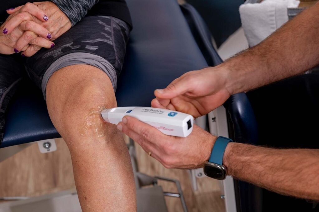 cold laser being used on a knee